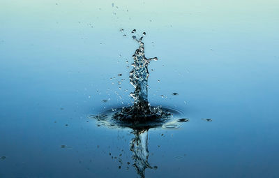 Close-up of splashing water against blue background