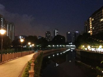 Illuminated cityscape against sky at night