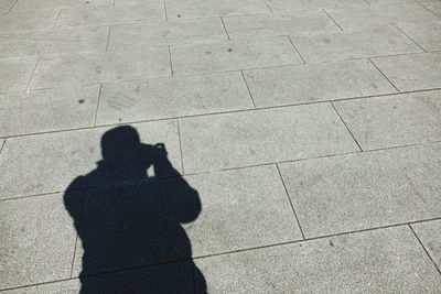 Shadow of man standing on wall