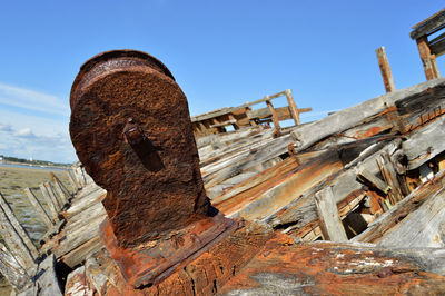 Old rusty wheel against clear sky