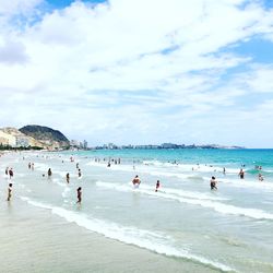 People on beach against sky