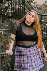 Full length of woman standing against plants