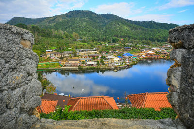 Scenic view of lake and mountains against sky