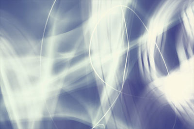 Low angle view of sun shining through clouds