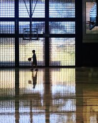 Side view of boy playing basketball at court