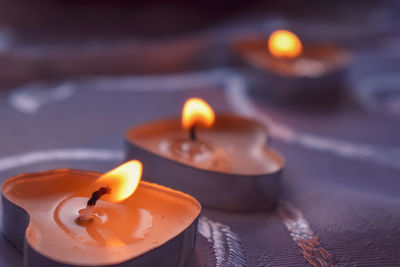 Close-up of lit candle in row