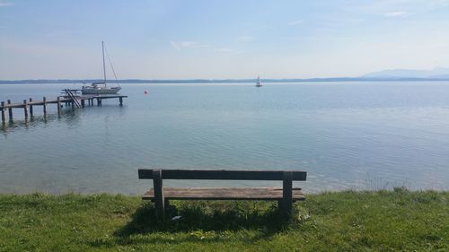 Empty bench overlooking calm sea