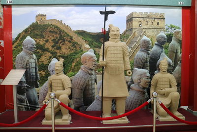 Statue of people in front of historical building