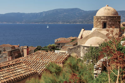 Historic building by sea against sky