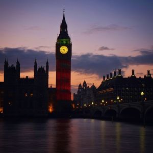 Illuminated big ben against sky at sunset