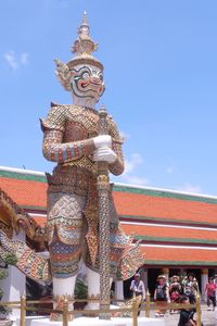 Statue of temple against building