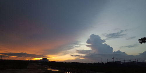 Silhouette of building against sky during sunset