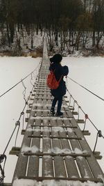 Full length of man walking on snow covered