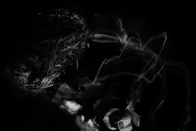 Digital composite image of man smoking against black background