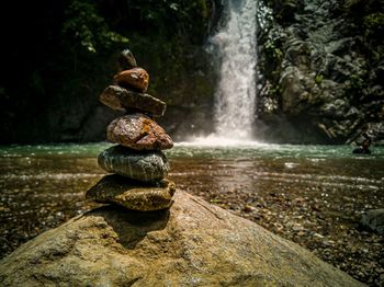 Stack of rocks in water at forest