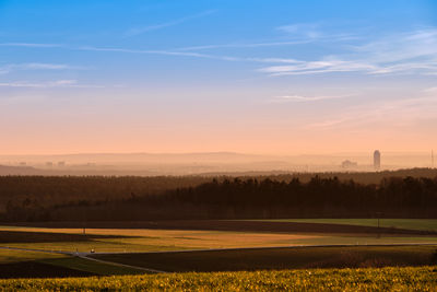 Scenic view of field against sky during sunset