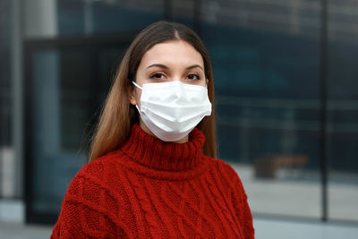 Portrait of beautiful woman wearing mask outdoors