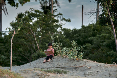 Rear view of woman walking on footpath