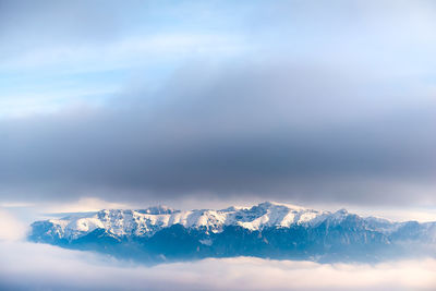 Scenic view of snowcapped mountains against sky