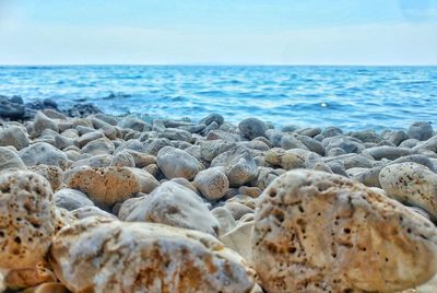 Rocks on beach against sky