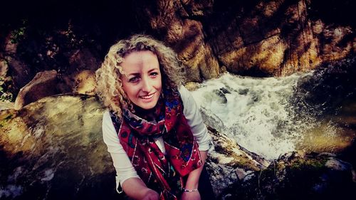 Portrait of woman standing on rock