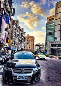 View of city street and buildings against sky