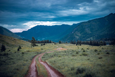 Scenic view of road by mountains against sky, altai, russia