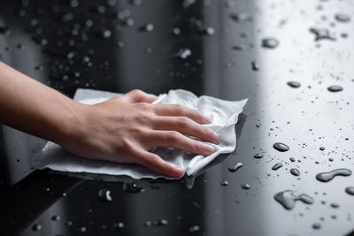 Close-up of woman hand holding wet glass