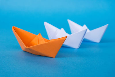High angle view of paper floating on blue table