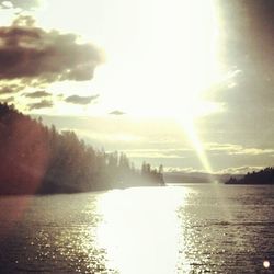 Scenic view of river against sky at sunset