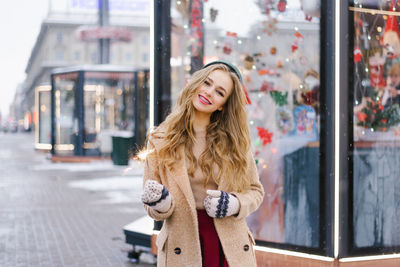 An attractive woman burns a sparkler at a city street fair. the girl has fun  christmas holidays