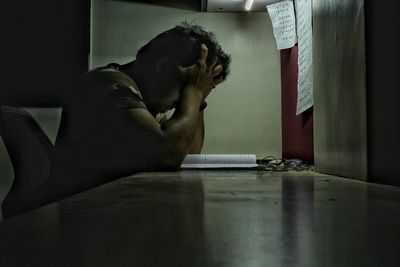 Side view of worried man at desk