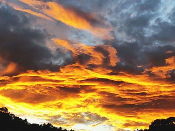 Low angle view of dramatic sky during sunset