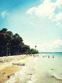 People on beach against sky