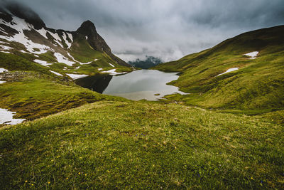 Scenic view of green mountains against sky