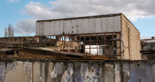 Abandoned factory warehouse with broken windows