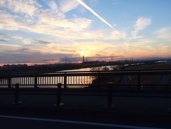 Bridge over river in city against sky