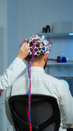 Rear view of woman sitting on chair