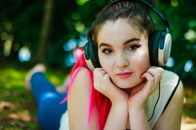 Young woman listening music in park