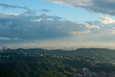 High angle view of cityscape against cloudy sky