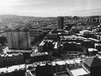 High angle view of buildings in city against sky