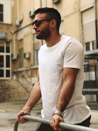 Young man wearing sunglasses in city