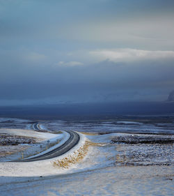 Rural road through snowy terrain in iceland