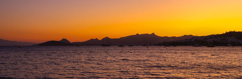 Scenic view of sea against orange sky