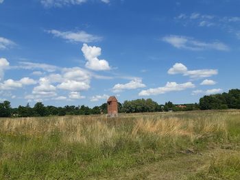 Built structure on field against sky