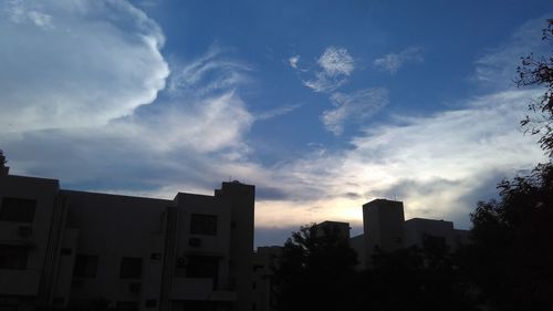 Low angle view of buildings against sky during sunset