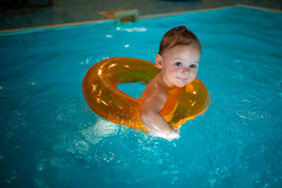 High angle view of boy swimming in pool