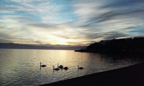 Scenic view of lake against sky at sunset