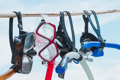 Close-up of motorcycle hanging against sky