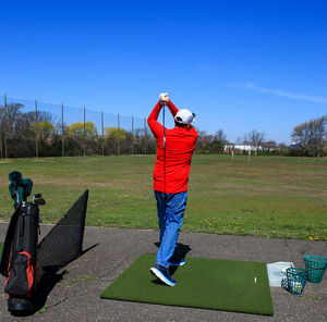 Rear view of man standing on field